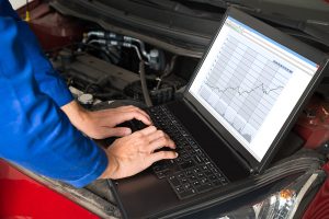 Mechanic Fixing Car With The Help Of Laptop