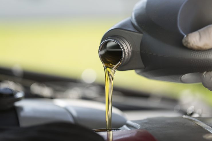 Fresh oil pouring into a car engine during service
